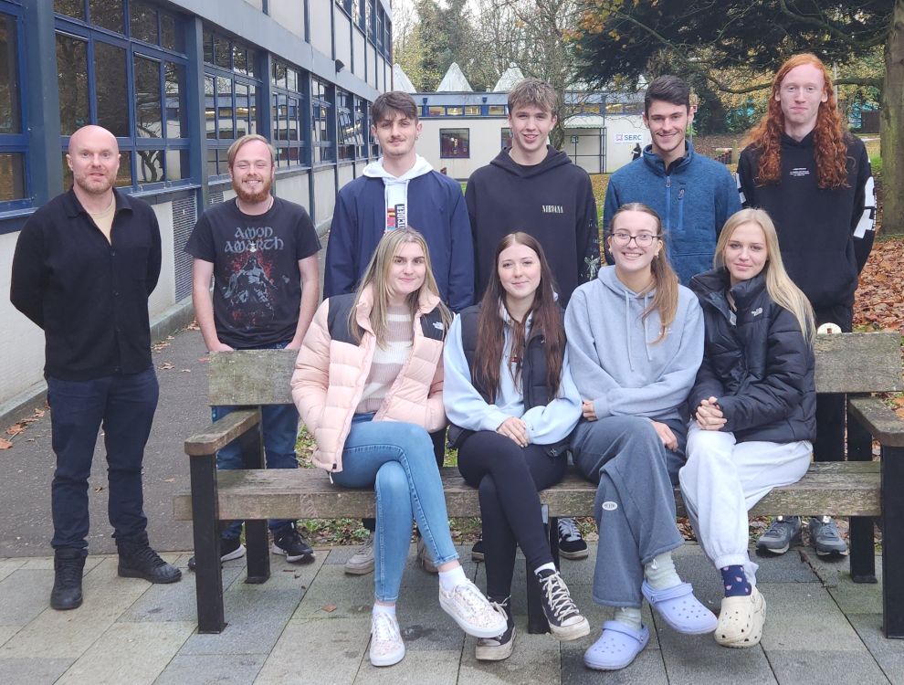 A group of students and their tutor , who are preparing for a sponsored sleep out, pictured outside SERC Bangor Campus